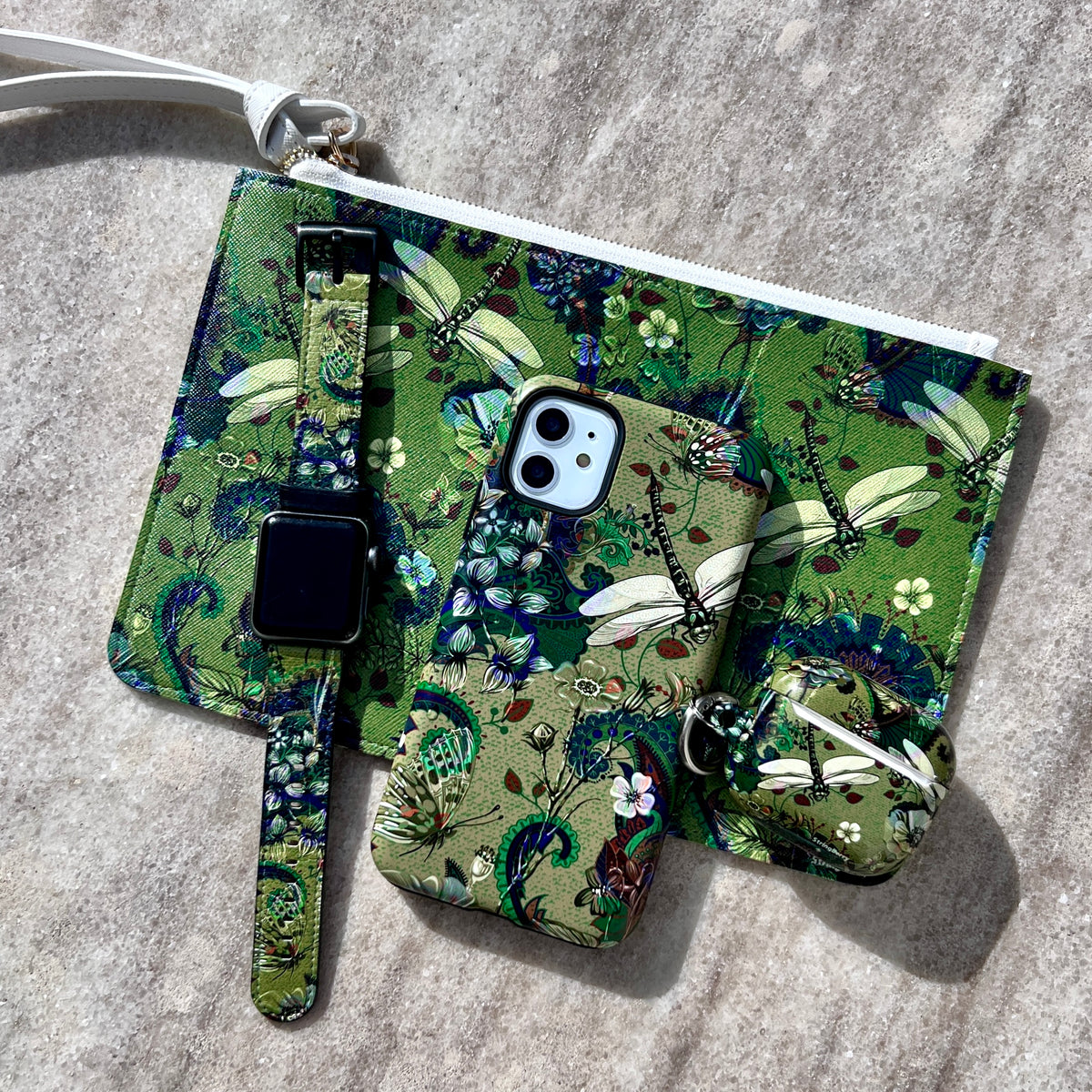 Vegan leather Apple Watch strap featuring a vibrant green dragonfly and floral print with stainless steel hardware.