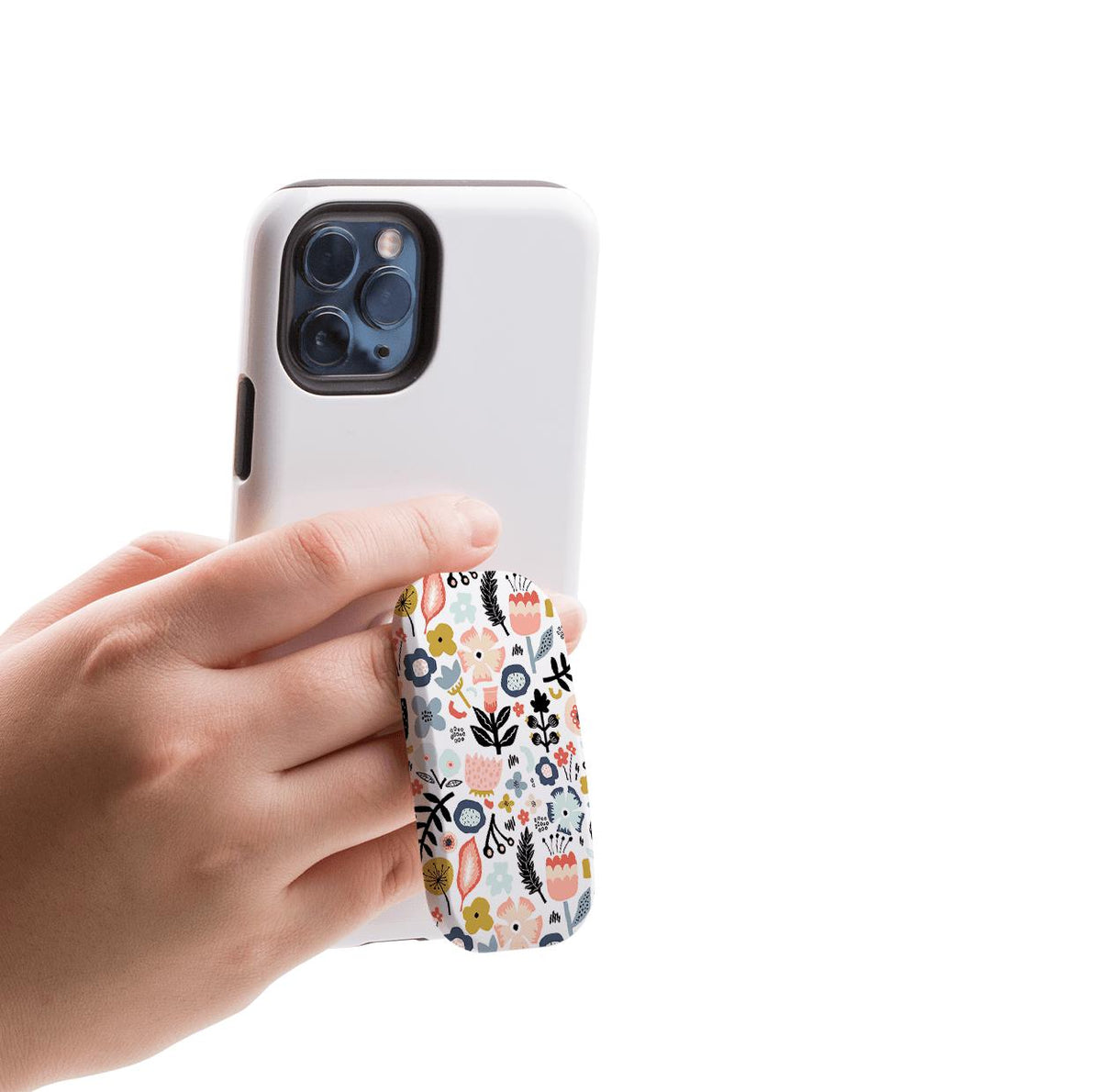 Hand holding a white smartphone with a floral-patterned Aarhus phone stand attached for a secure grip.