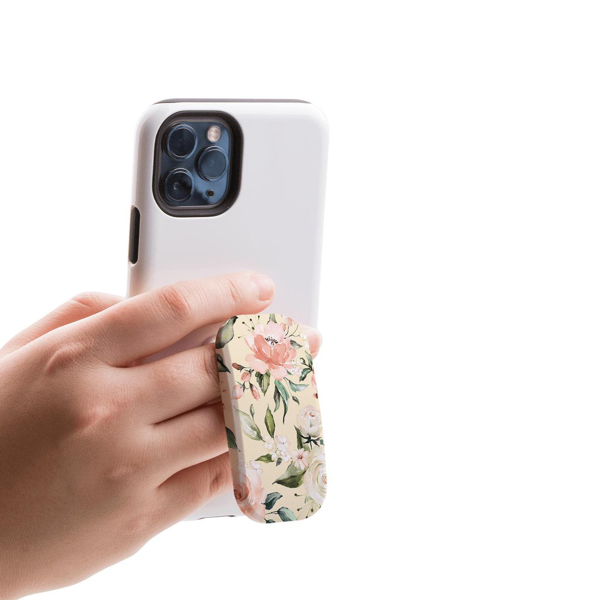 Hand holding a white smartphone with a floral-patterned Abinger Clickit phone stand attached to the back.
