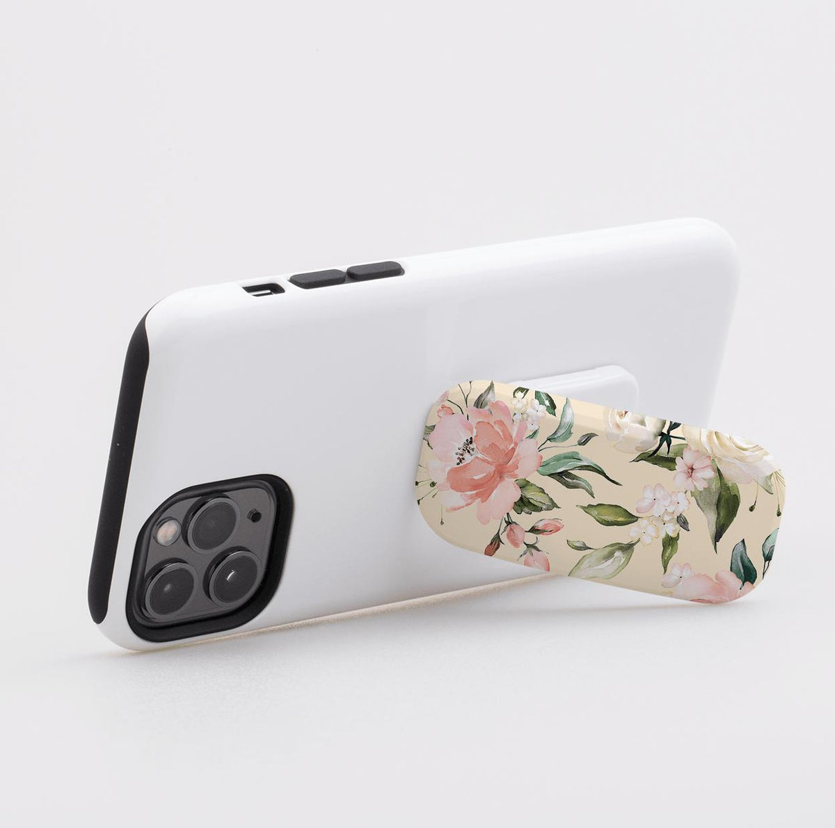 Abinger phone stand with a cream floral print attached to the back of a white smartphone for a secure grip and stand.