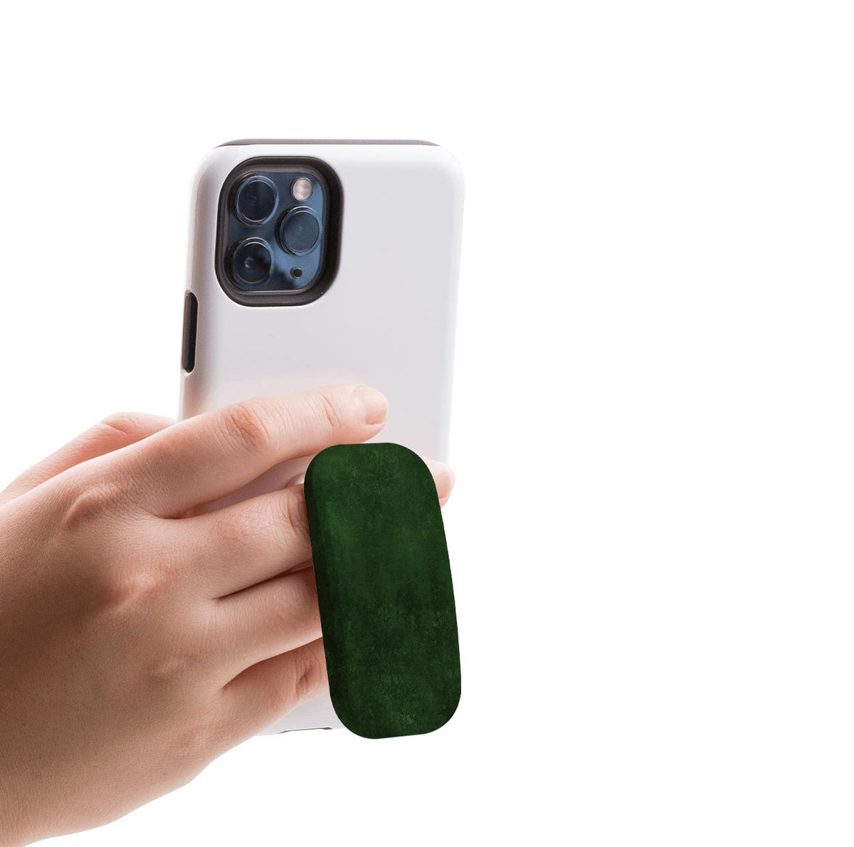 Hand holding a white smartphone with a dark green, textured oval Clickit phone stand attached to the back.