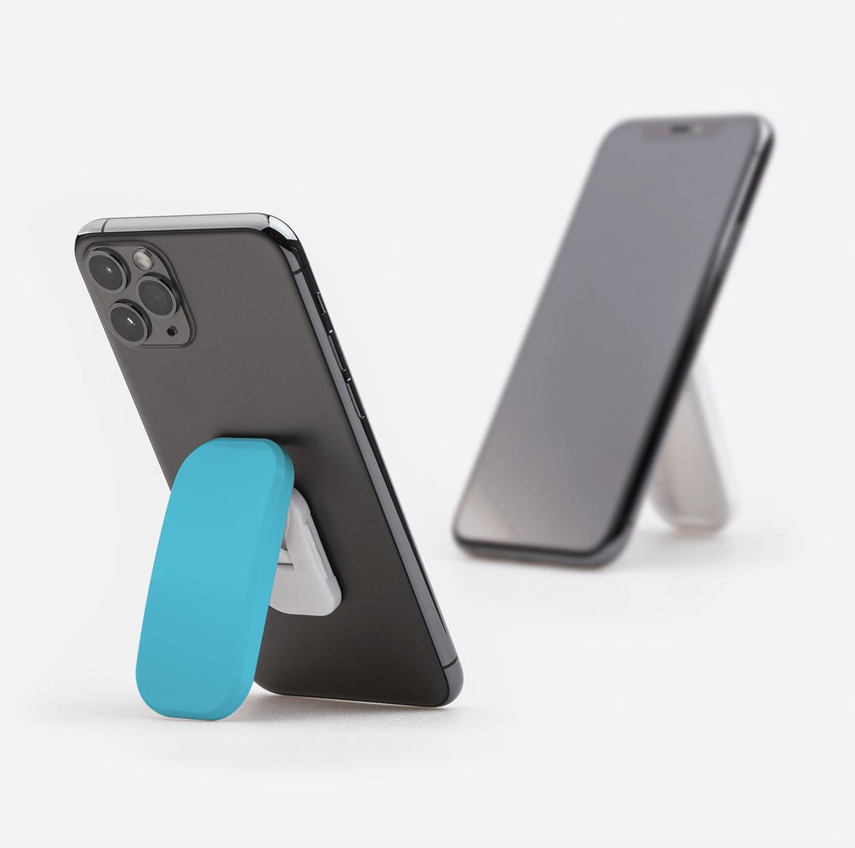 Aqua Sky Clickit phone stand attached to a black smartphone, functioning as a convenient portrait and landscape kickstand.