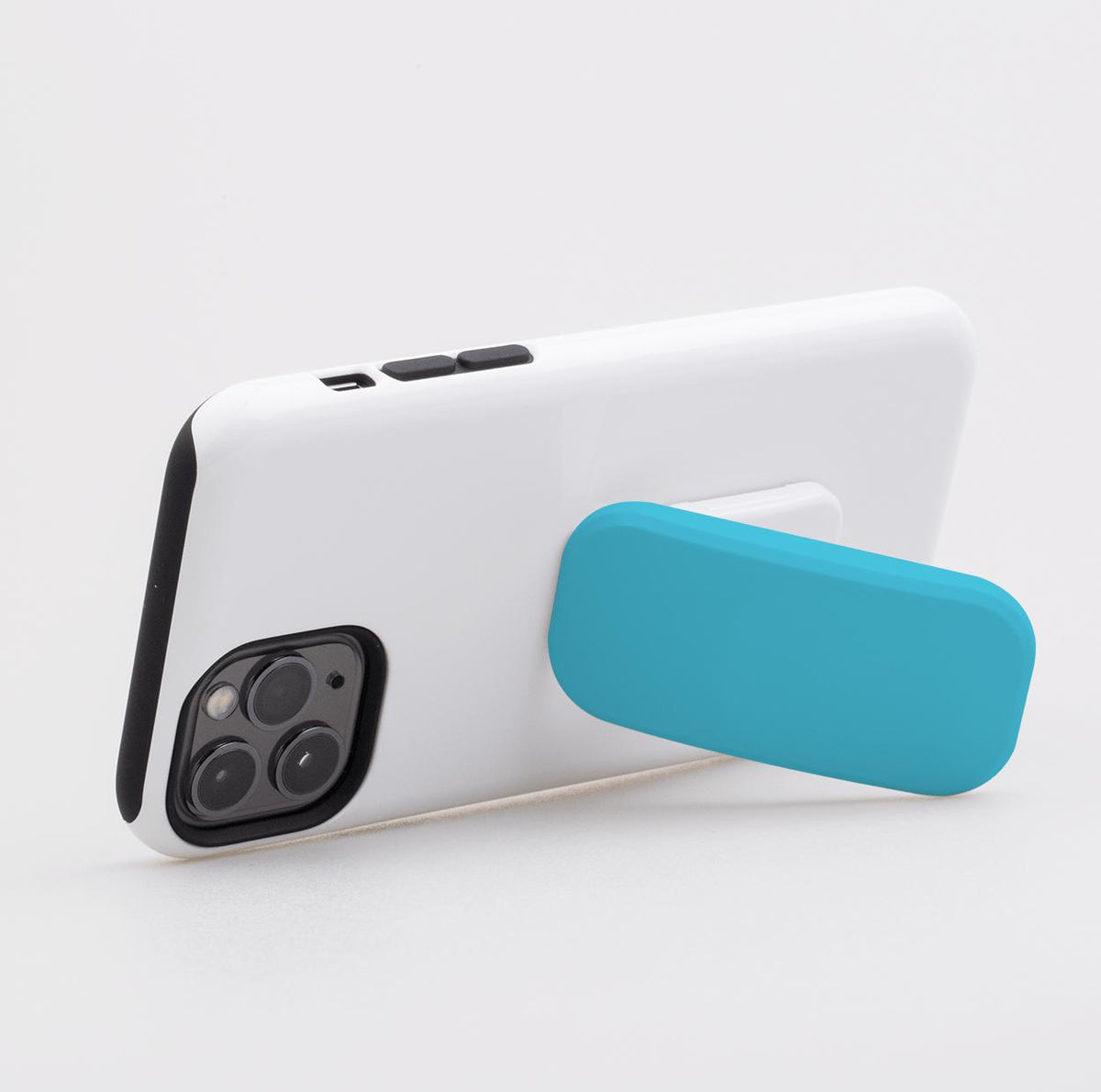 Aqua Sky rectangular phone stand attached to the back of a white smartphone case, providing a secure grip and landscape stand.