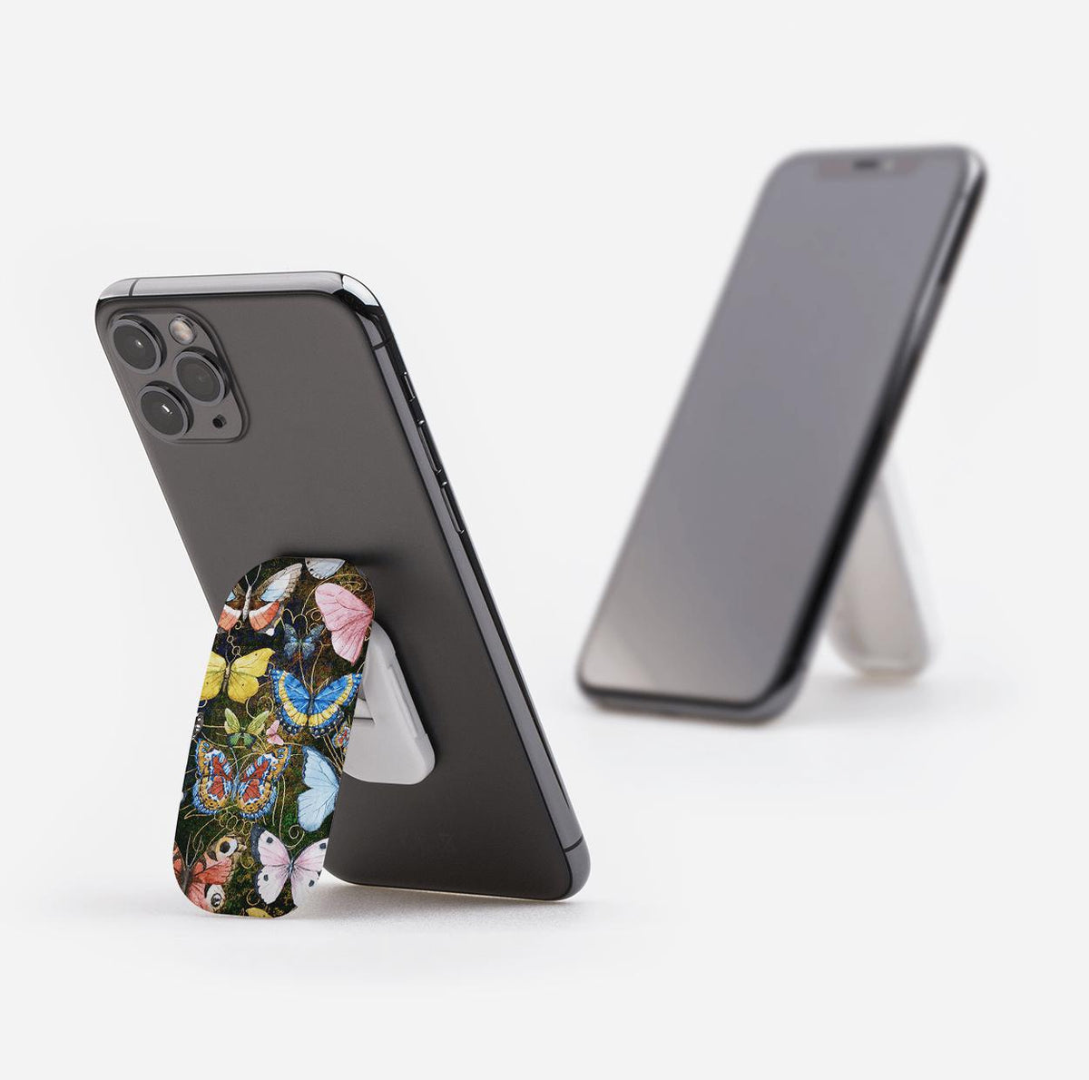 Arebury phone stand with a colorful butterfly pattern attached to the back of a smartphone, propped up on a white background.