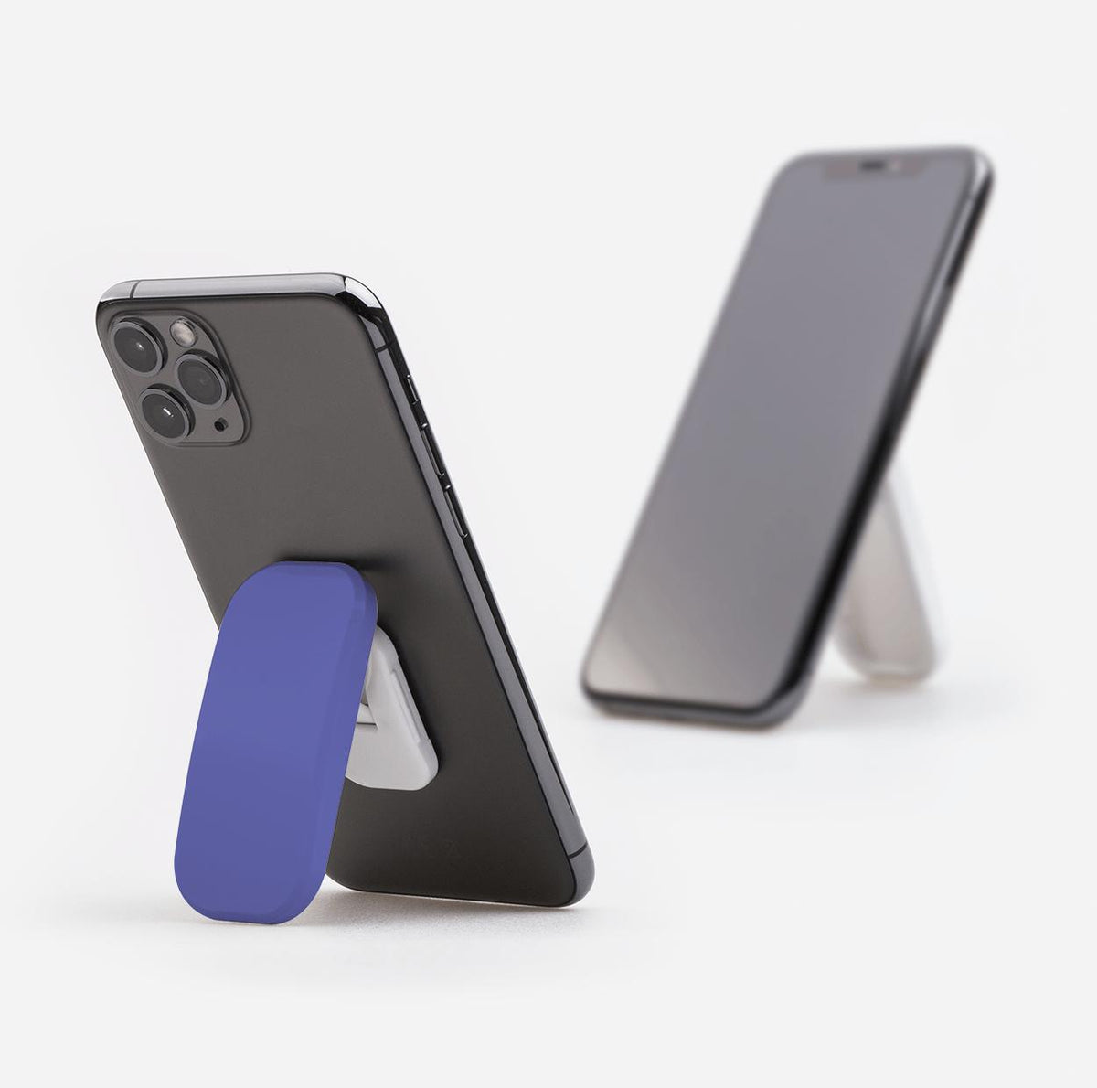 Atomic purple Clickit phone stand attached to a smartphone, functioning as a sturdy kickstand on a white background.