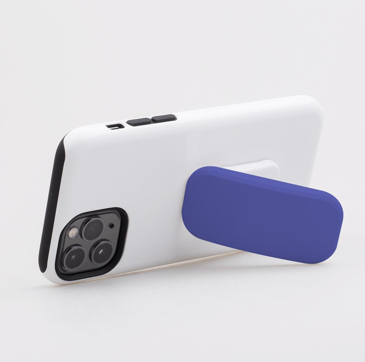 Atomic purple rectangular phone stand attached to the back of a white smartphone, acting as a horizontal kickstand.