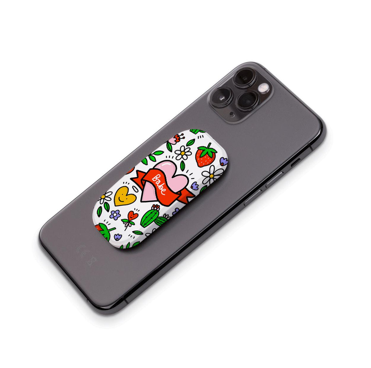 Babe Flickit phone stand with a white background, heart, strawberry, and cactus doodle print attached to a grey smartphone.