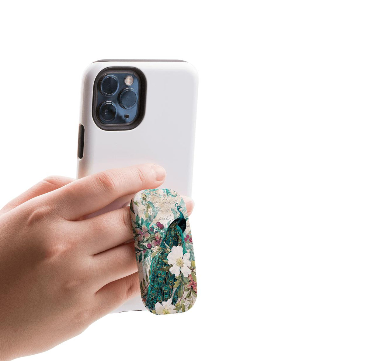 Hand holding a white smartphone with a floral and peacock patterned Clickit phone stand attached to the back.
