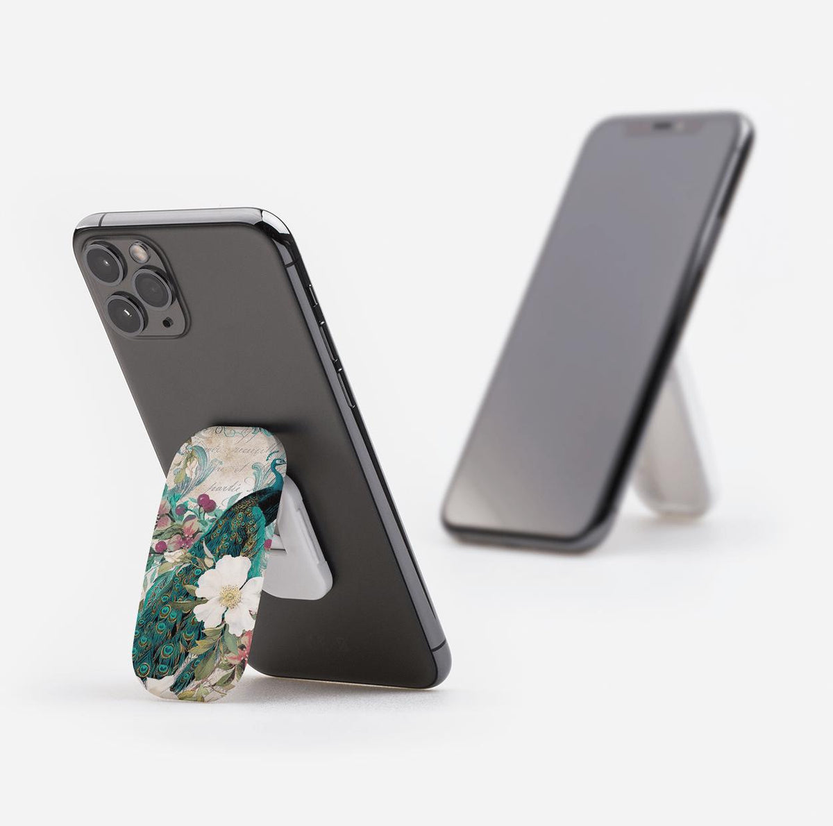 Peacock and floral patterned Clickit phone stand attached to a black smartphone, functioning as a landscape and portrait stand.