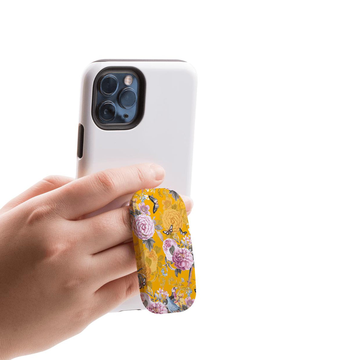 Hand holding a white smartphone with a yellow floral-patterned Barnes phone stand attached for a secure grip.