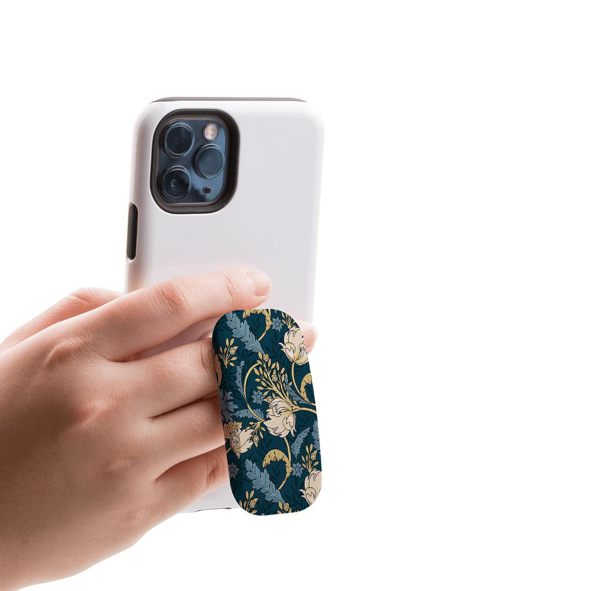 Beeston phone stand with a dark blue floral pattern attached to the back of a white smartphone held by a hand.