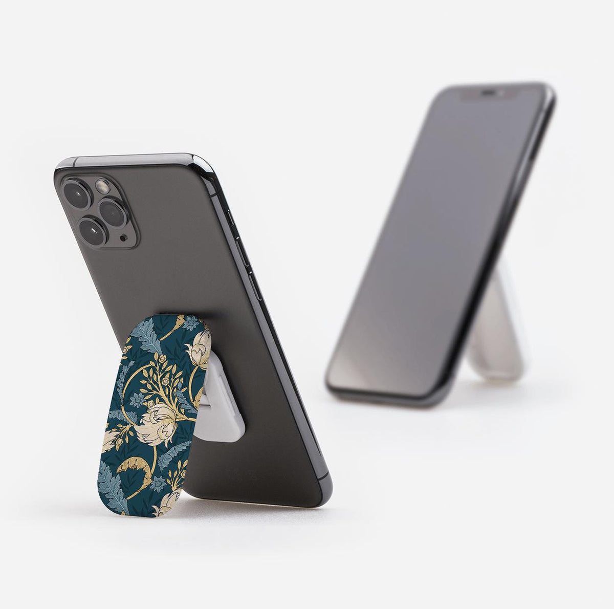 Beeston phone stand with a dark blue floral pattern attached to the back of a smartphone, acting as a landscape kickstand.