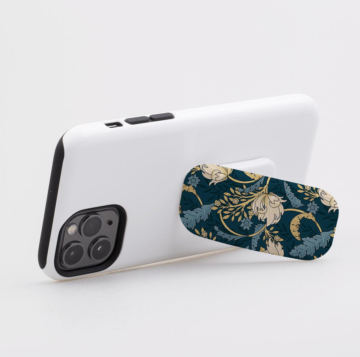 Beeston phone stand with a dark blue floral pattern attached to the back of a white smartphone case.