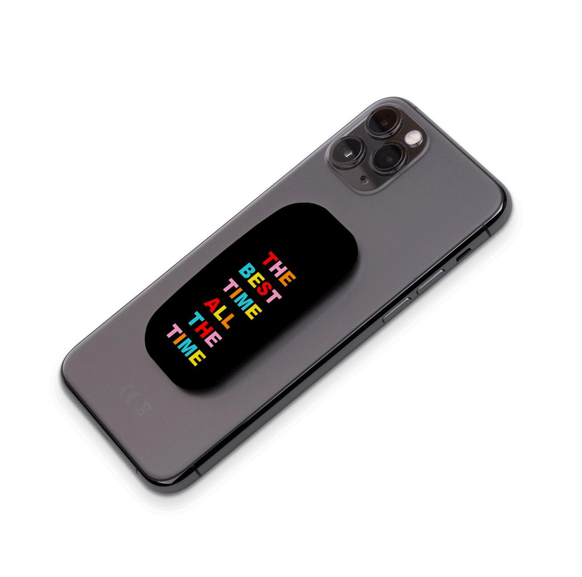 Black Flickit phone stand with colorful text reading The Best Time All The Time attached to a grey smartphone.