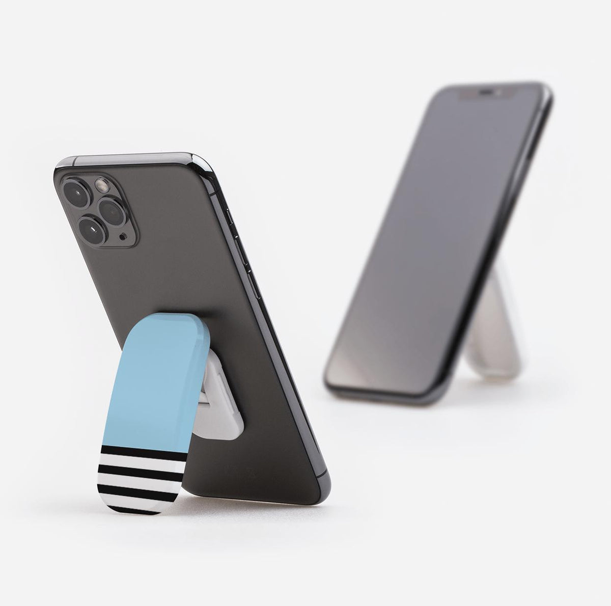 Collapsible phone stand with a light blue and black striped design attached to the back of a smartphone.
