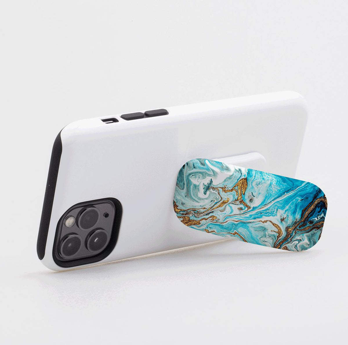 Blue Royal Flickit phone stand with a swirling blue and gold marble pattern attached to the back of a white smartphone.