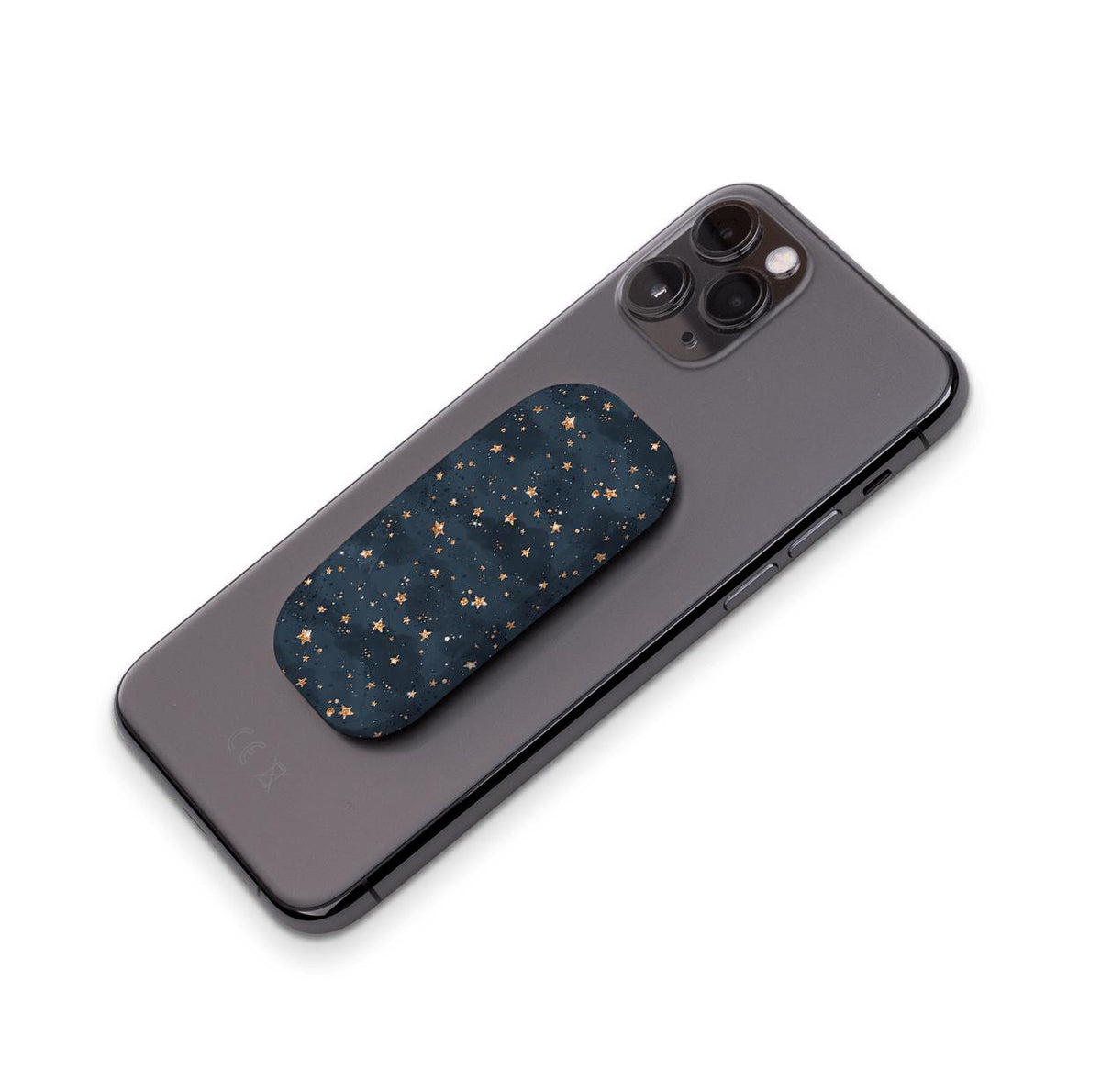 Bode Galaxy phone stand with a navy blue starry pattern attached to the back of a black smartphone.