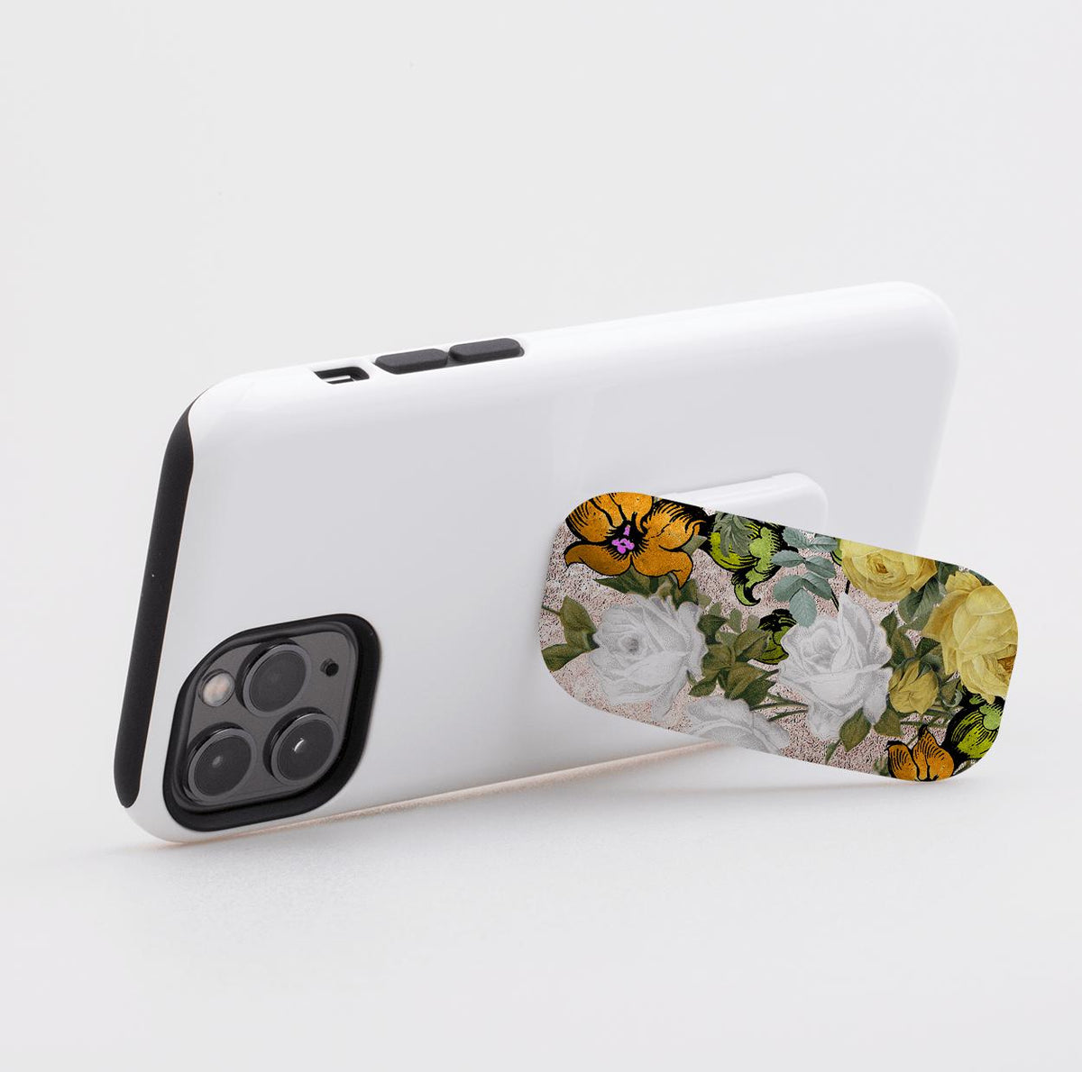 Floral Bowes phone stand attached to a white smartphone, featuring a vintage rose pattern in yellow, white, and green.
