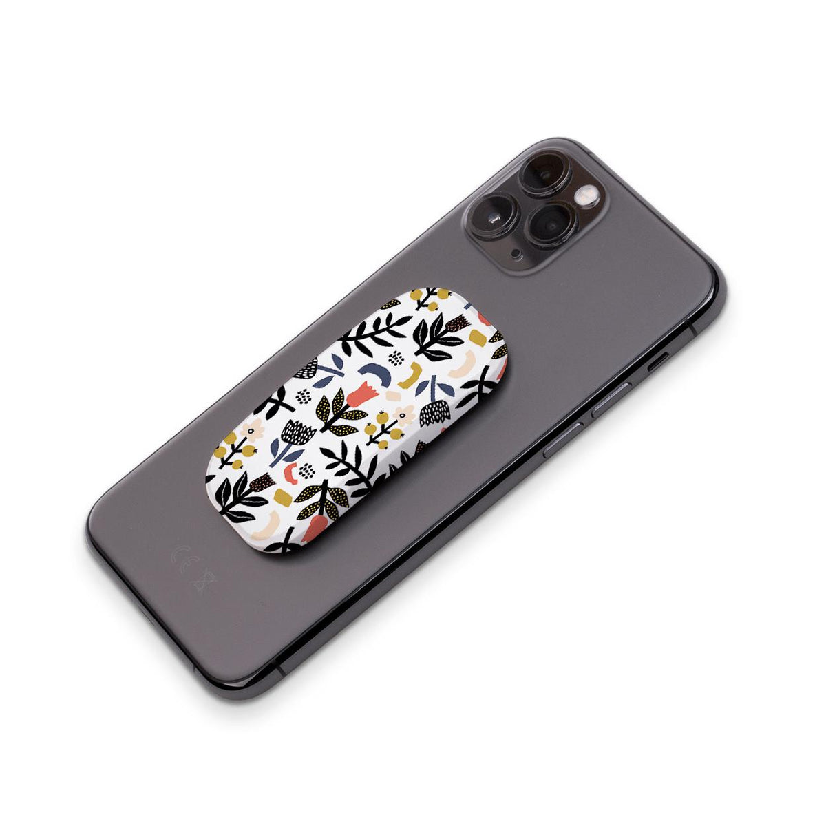 Broad Oak phone stand with a white, floral, and abstract pattern attached to the back of a black smartphone.