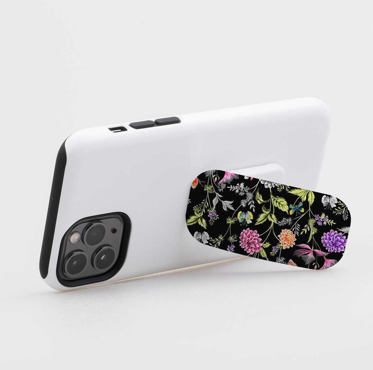 Broadview phone stand with a black floral pattern attached to the back of a white smartphone case.