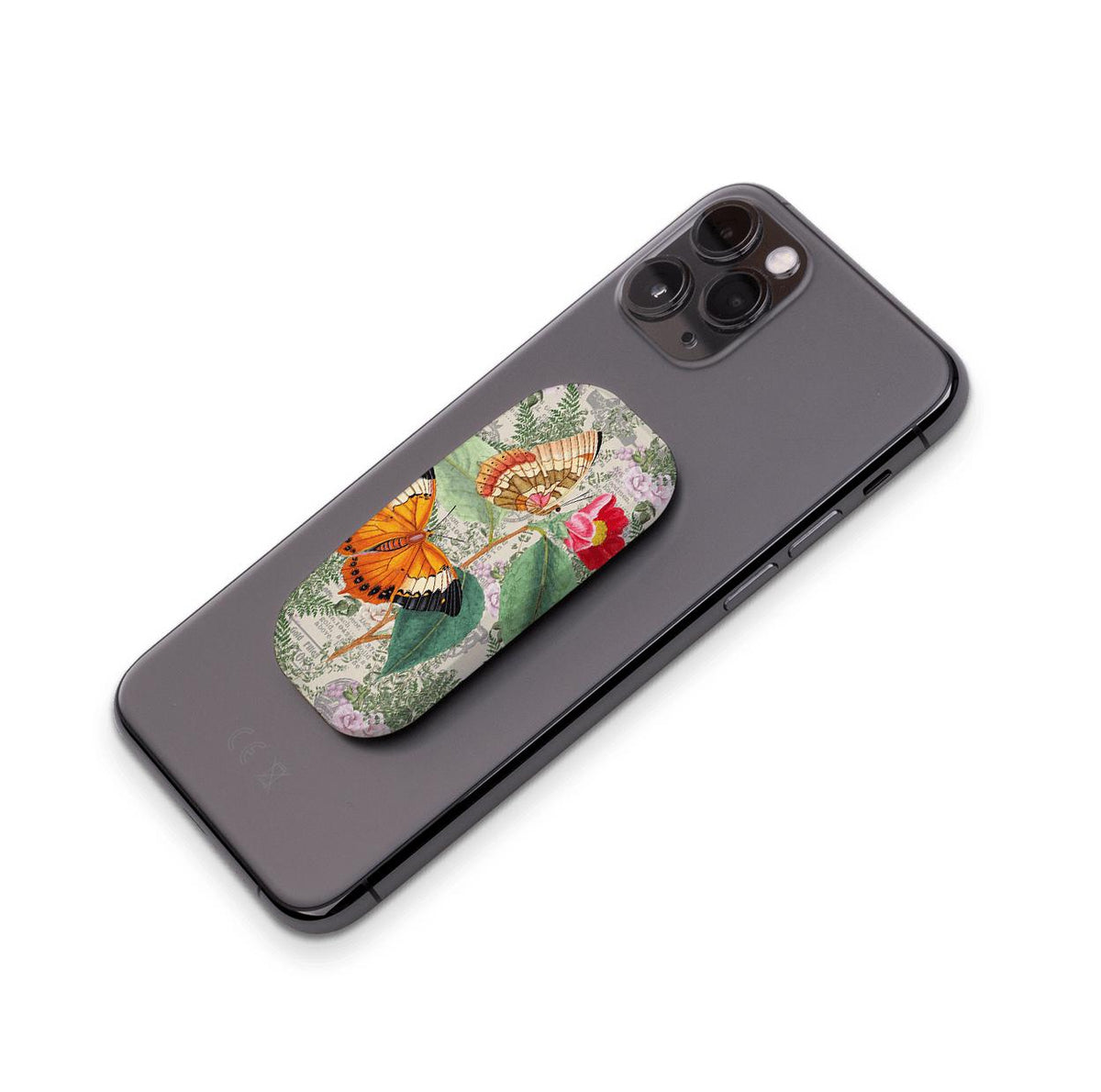 Butterfly Stories Clickit Handyhalter mit vintage botanischer Schmetterlingskunst, die an der Rückseite eines schwarzen Smartphones befestigt ist.