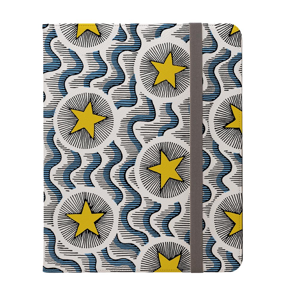Celestial vegan leather iPad Pro case with a yellow star and blue wave pattern, featuring a flat grey elastic closure.