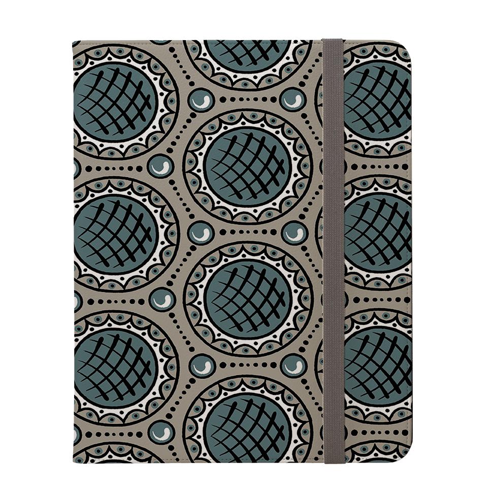 Charleston Green vegan leather iPad Pro case with a geometric circular pattern and a grey elastic strap closure.