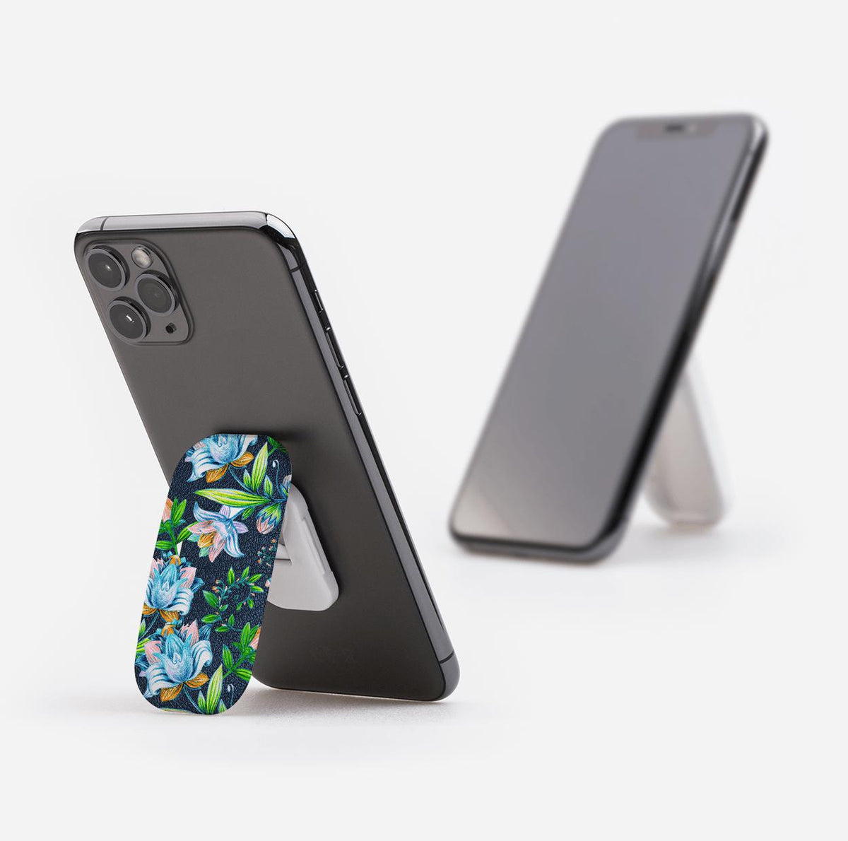 Chester phone stand with a blue floral pattern attached to the back of a smartphone, acting as a prop-up stand.