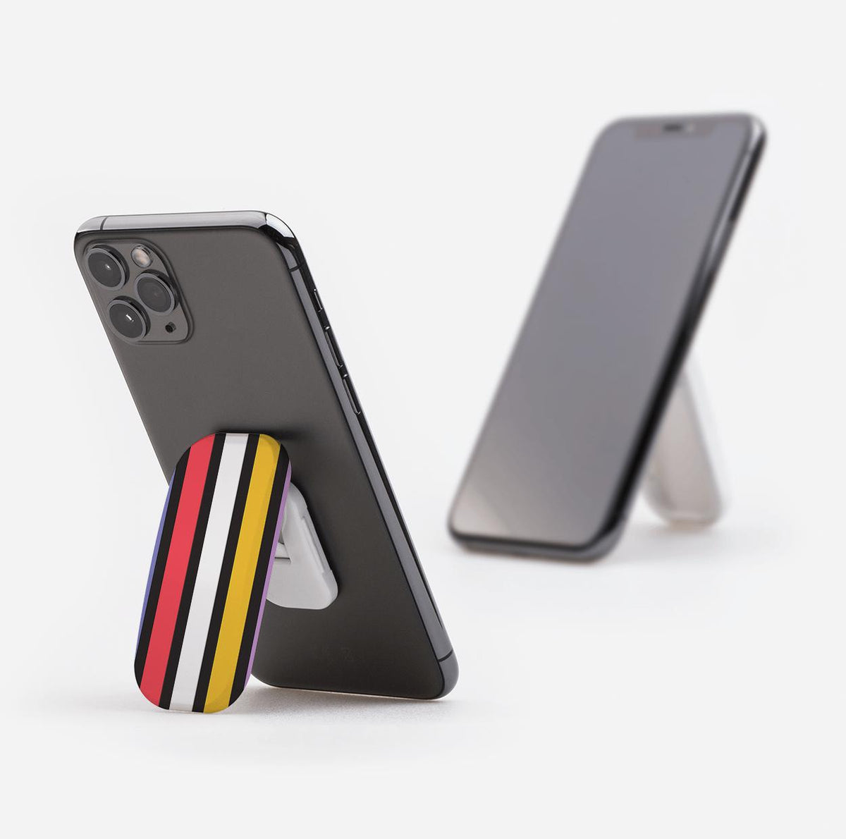 Cheyenne phone stand with red, white, black, and yellow stripes attached to the back of a smartphone acting as a kickstand.