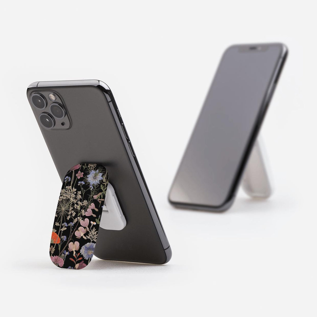Clickit phone stand with a dark floral botanical print attached to the back of a smartphone, shown in portrait and landscape.