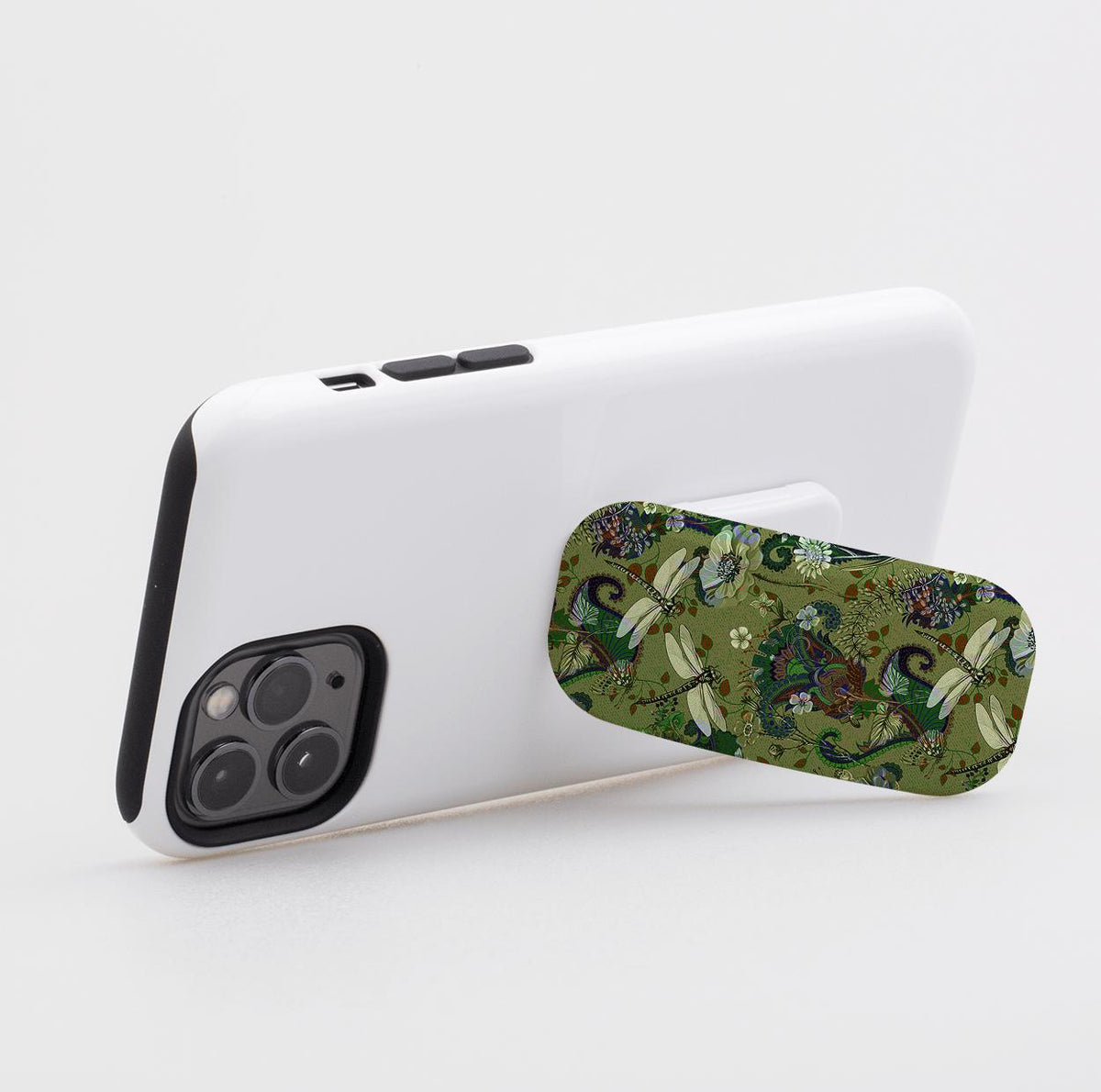 Vyne pattern Clickit phone stand with a green dragonfly and floral design attached to the back of a white smartphone.