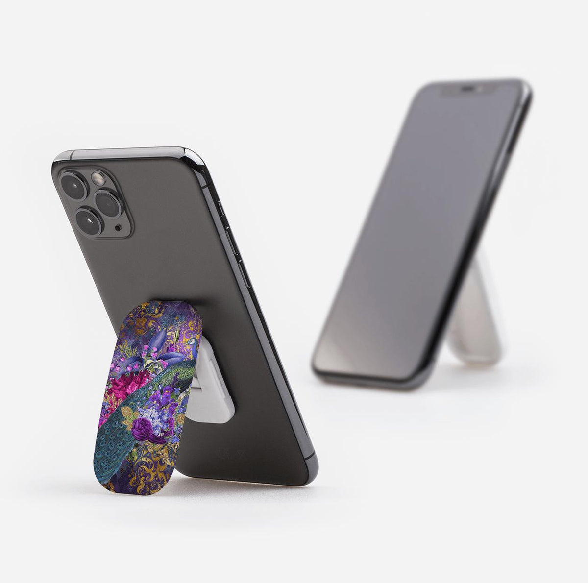 Wonders Phone Stand with a vibrant floral peacock pattern attached to the back of a smartphone, acting as a kickstand.