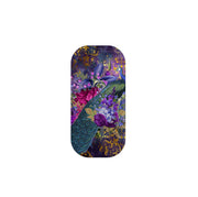 Wonders phone stand featuring a vibrant peacock and floral design in shades of purple, blue, and gold on a pill-shaped grip.